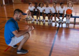 Der Coach erklärt den KIndern die Regeln im Basketball